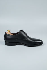 Black leather lace-up dress shoes with a classic design for formal occasions.